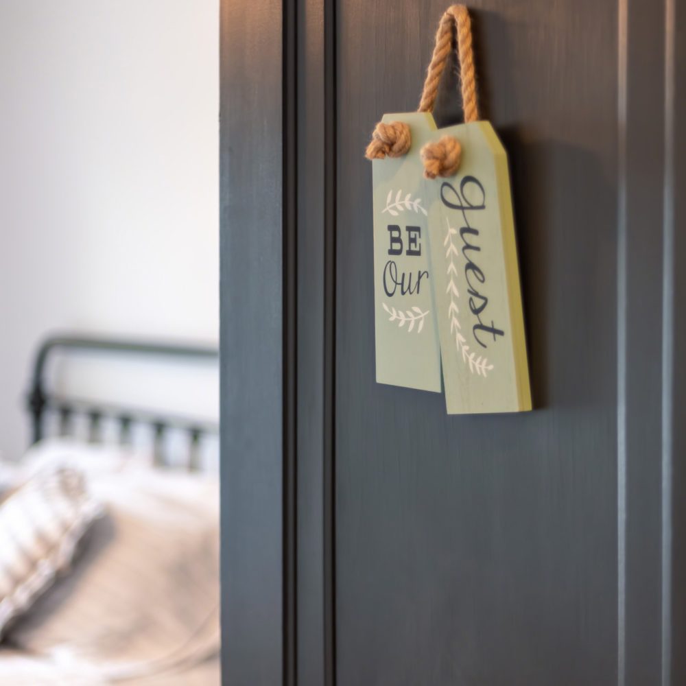 Open door of guest bedroom in old house (vertical)